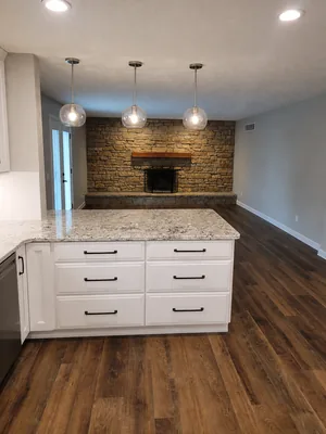 Kitchen with gathering space by KNA Remodeling