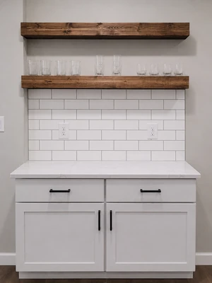 Custom built-in cabinetry with floating wood shelves and white tile backsplash by KNA Remodeling